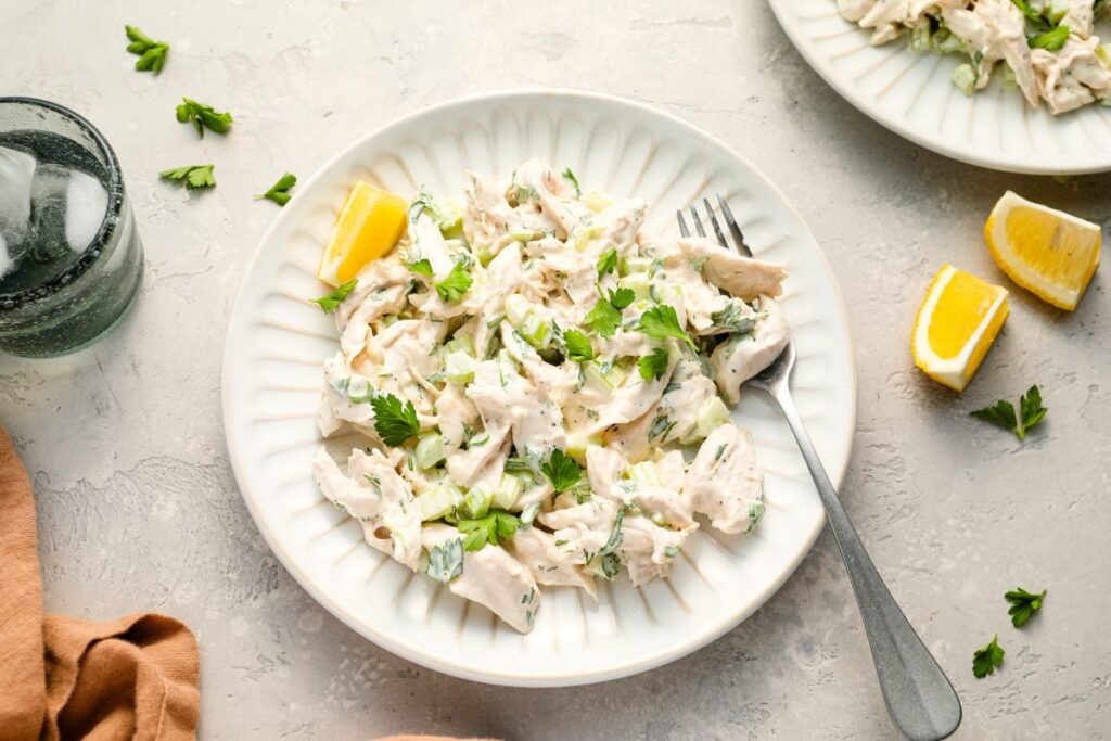Chicken salad on a plate with fork.