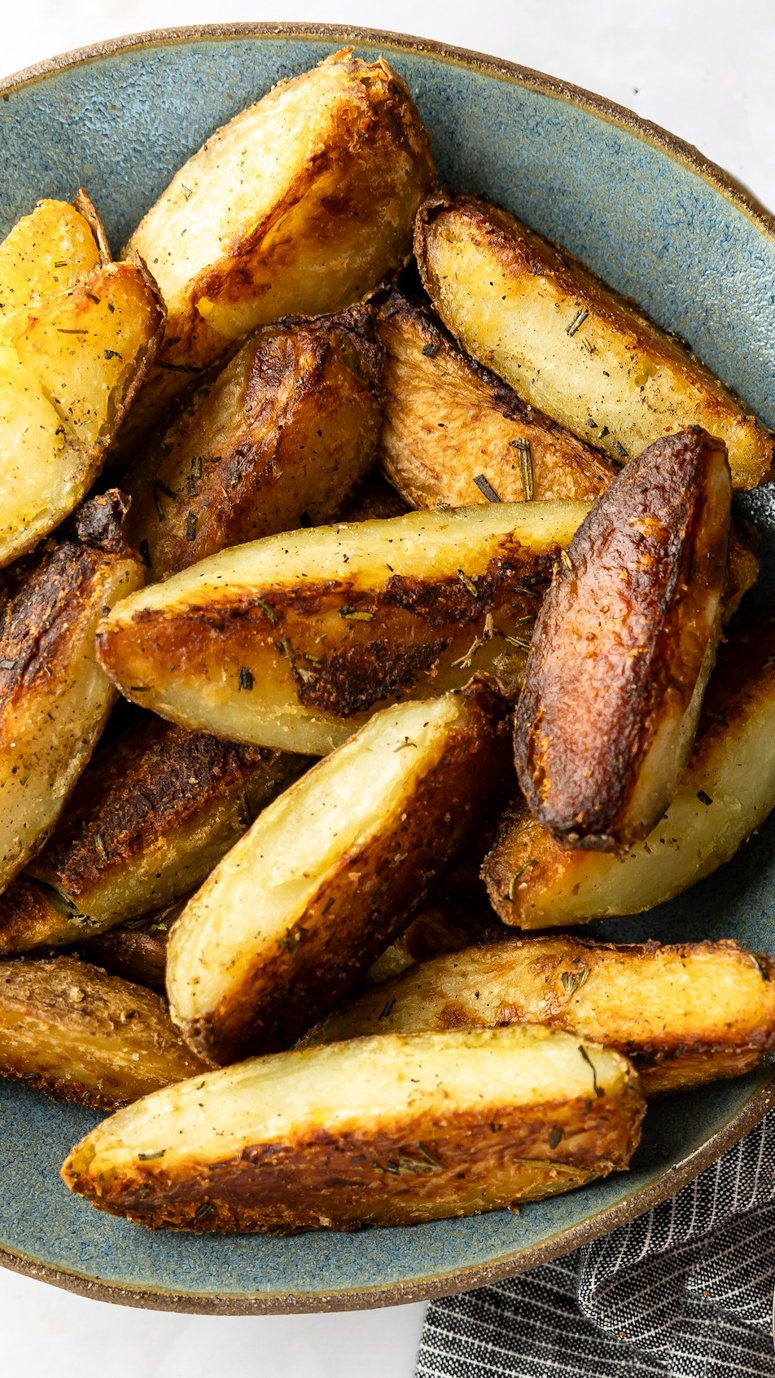 crispy baked potato wedges in gray bowl