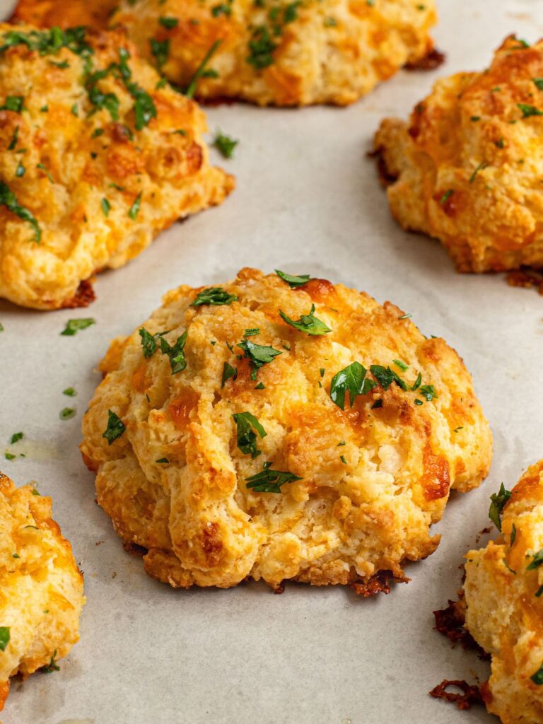 cheddar bay biscuits on baking sheet