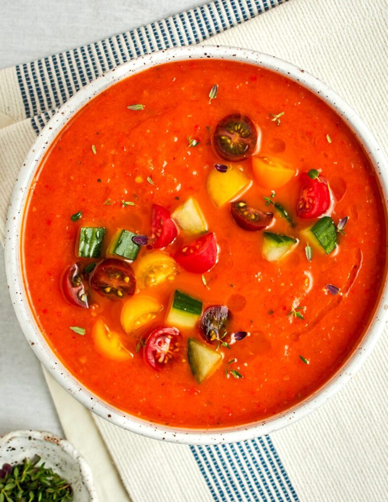 roasted red pepper and tomato gazpacho garnished with diced cucumbers and tomatoes