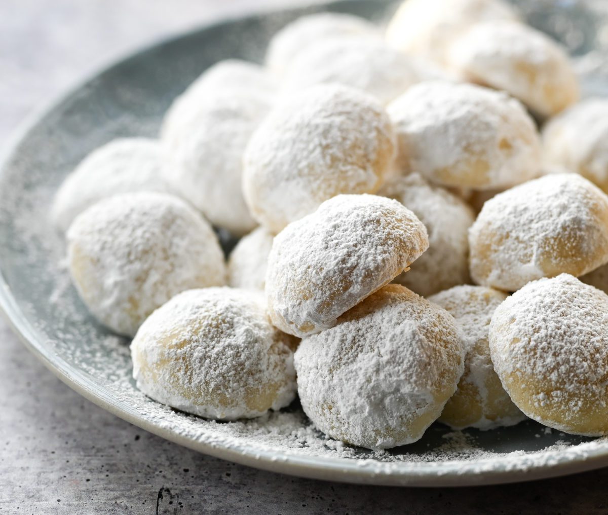 Snowball cookies piled on a plate.